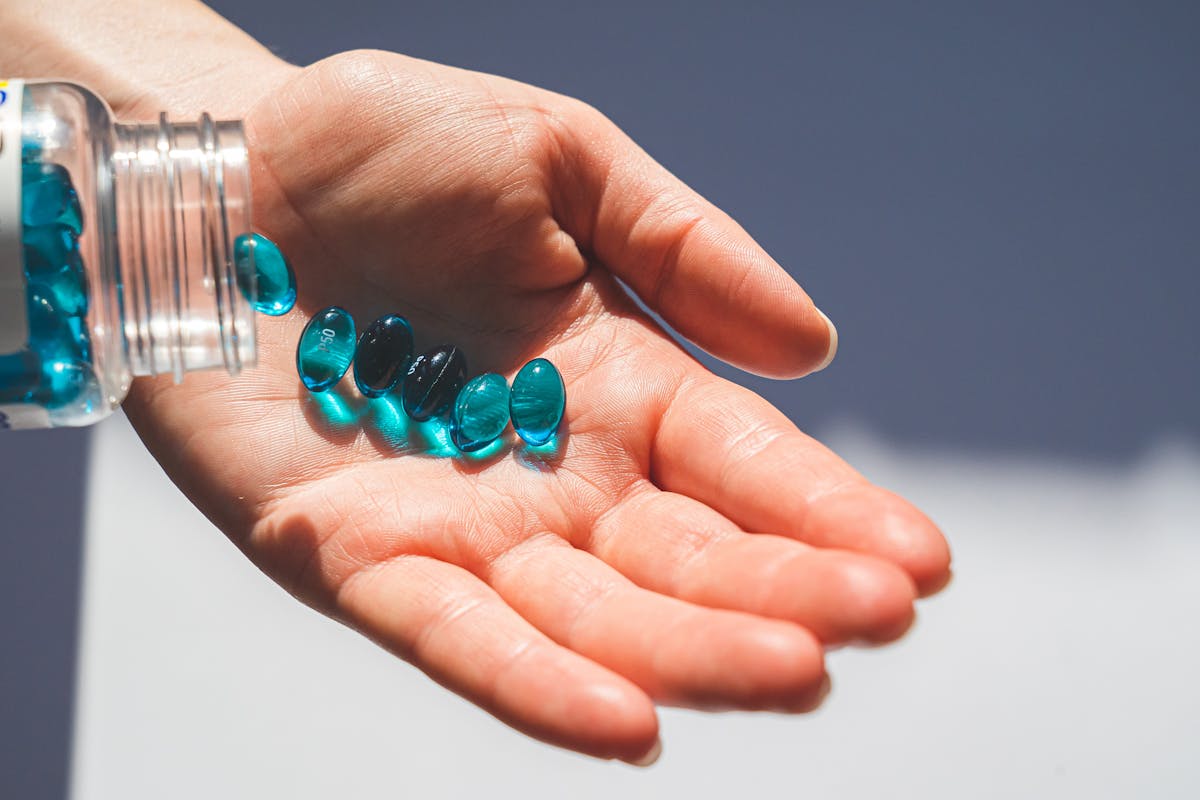 Melatonin supplement capsules being poured from bottle